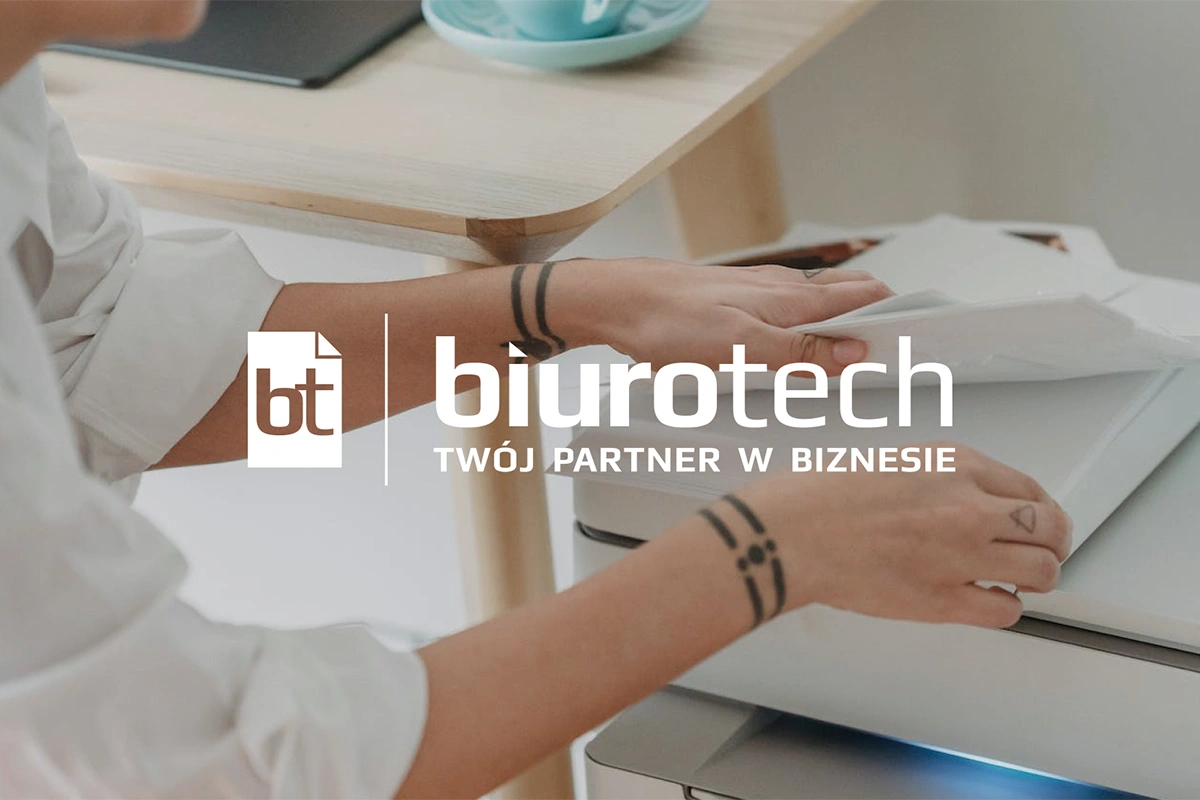 Logo "biurotech" z dynamiczną typografią, symbolizującą nowoczesność i profesjonalizm. Tekst "Twój partner w biznesie" podkreśla oferowane wsparcie technologiczne i biurowe.